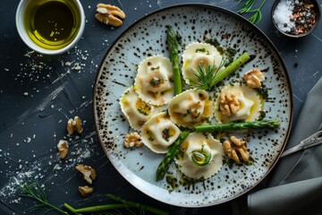 Goat's cheese ravioli with green asparagus, walnuts, chilli flakes and olive oil - obrazy, fototapety, plakaty