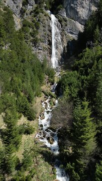 View to the dalfazer Waterfall with forest landscape and the Achensee as a close neighbor