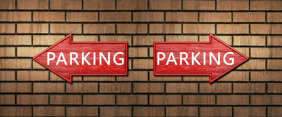 Red wooden arrow signs with the inscription PARKING hang on a dark brick wall. Right and left arrow...