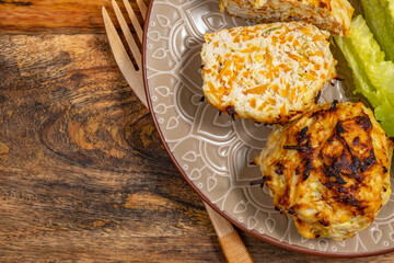 Chicken Vegetables Cutlets on white platter over wooden background.