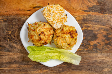 Chicken Vegetables Cutlets on white platter over wooden background..