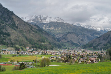 Fototapeta na wymiar Panoramic view of Predazzo. Val di Fiemme in Trentino Alto Adige. The snow-capped Latemar mountain in the background of Predazzo. Spring