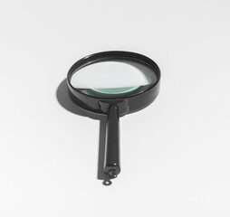 Office analysis with magnifying glass, zooming in on details. Quality inspection, crime study,