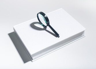 magnifying glass, studying books. Detailed examination of literature, educational research in