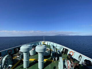 A view of the Isle of Arran in Scotland on a sunny day from the sea