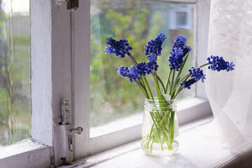 flowers in a vase on the windowsill