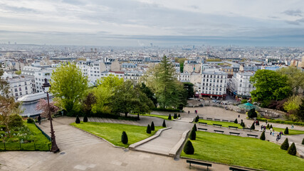 Breathtaking panoramic view of Paris from Montmartre with lush greenery and urban landscape, ideal for travel and tourism themes related to European cities
