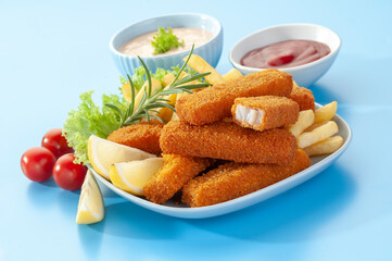 Fried Breaded fish Fingers with salad and condiments 