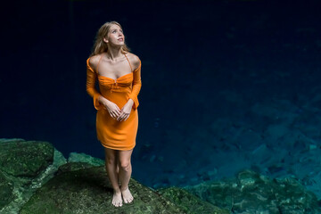 Serenity Unveiled: A Stunning Model's Bliss Amidst Cuzama's Enchanting Blue and Green Cenotes in Yucatan, Mexico