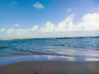 View of the waves of a turquoise sea reaching the seashore, resting place on Brazil beach, Rio Grande do Norte, 