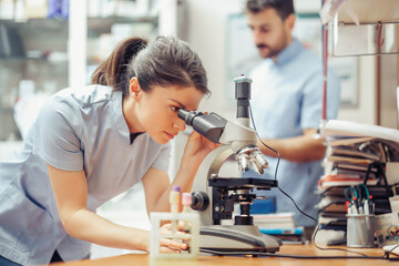  Doctor Examining Microscope Slide