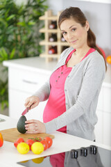 pregnant woman preparing healthy vegetables