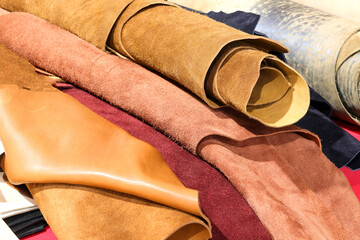 rolls of leather and tanned leather scraps for artisanal clothing creations for sale in the...
