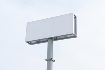 White Street Sign Against Sky