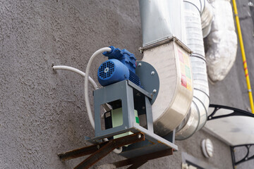 Exterior Ventilation System Mounted on a Building Wall in an Urban Setting
