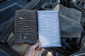 Clean and dirty cabin air filter for car. seasonal car maintenance