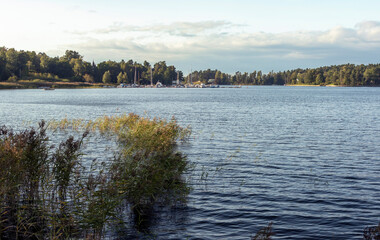 The surface of the lake under a cloudy sky on an autumn evening