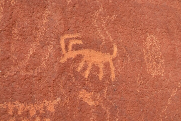 Close up view of Native American rock art (Petroglyphs) on red Aztek sandstone wall of Atlatl Rock...
