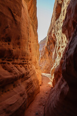 Hike in the narrow Kaolin Wash slot canyon along White Domes Hiking Trail in Valley of Fire State...