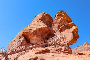 Scenic view of staircase of Atlatl rock showing the ancient Indian petroglyphs carvings of the Anasazi in Valley of Fire State Park in Mojave desert, Nevada, USA. Aztek red sandstone rock formation