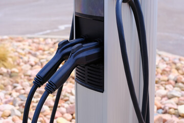 Electric vehicle charging station close-up photo. EV charger for electric cars. Alternative fuel,...