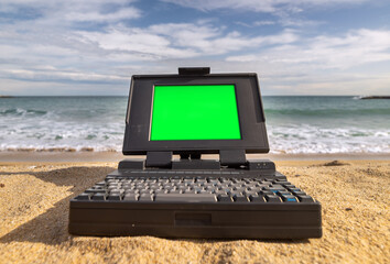 laptop computer system by the sea green screen