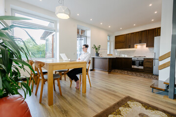 Woman working in modern private home interior