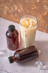 Cold brew coffee with milk and cold brew coffee in bottles angle view