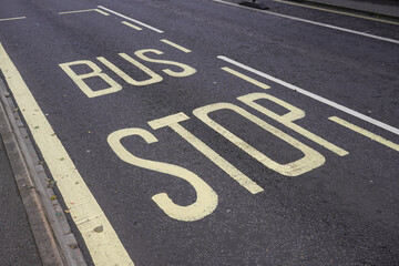 Bus Stop sign painted on road. bus lane markings. public transport  - Powered by Adobe