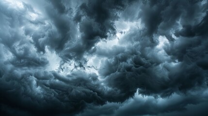 Obraz premium A dramatic scene of intense black clouds gathering before a thunderstorm, creating a moody and ominous atmosphere.
