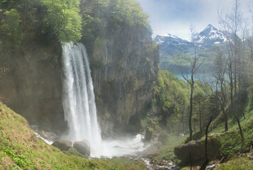 The Seerenbach Falls in spring with lots of water and a blue sky