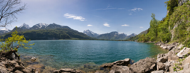 Large panorama of Lake Walen in Switzerland with a blue sky
