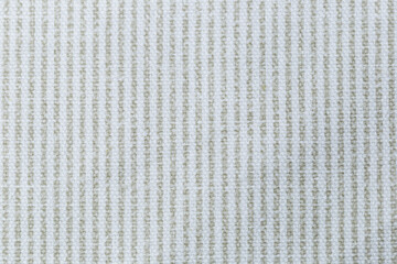 A white and green vertical striped fabric with a pattern of squares. The fabric is very plain and simple. Texture.