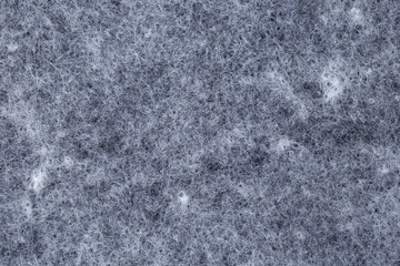 Detail of the texture of a gray and white thread rug.