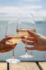 A celebratory toast at the coast, with a shallow depth of field
