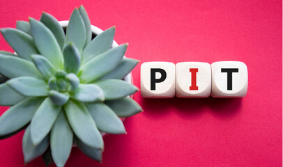 PIT - Personal Income Tax symbol. Wooden cubes with words PIT. Beautiful red background with...
