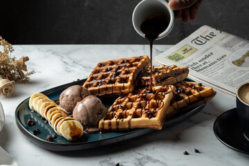 Chocolate waffle served with chocholate syrup