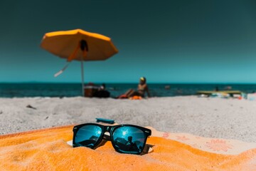 glasses and umbrella on a beach