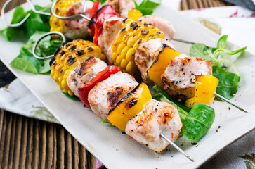 Traditional barbecued German schaschlik chicken skewer with chicken fillet and vegetable served as...