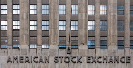 A close up on the façade of American Stock Exchange in New York City. The name is located at the bottom. rows of symmetrical windows. Simple and neat architectural style.