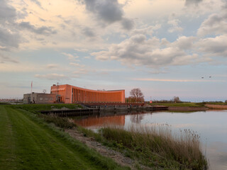  Large pumping station beside bridge and sluice and historic town of Stavoren with canal, lake, and waterways