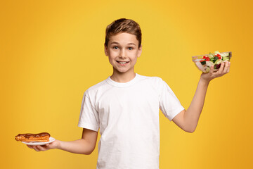 Young Boy Holding a Sandwich and Salad