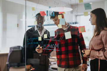 Dynamic office scene capturing a young, diverse group of colleagues brainstorming and analyzing...