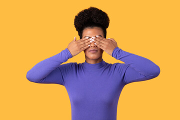 Woman Covering Eyes With Hands on Yellow
