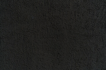 Black plastered old wall. Abstract construction background.