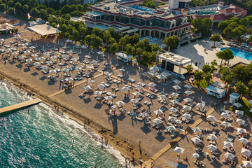 An aerial view of a bustling sandy beach resort in Turkey