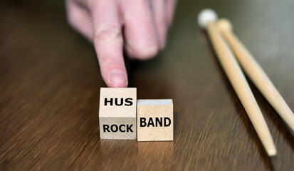 Symbol for getting married and stop to be in a rock band. Hand turns cube and changes the expression rock band to husband.