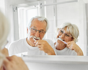 Obraz premium woman tooth bathroom toothbrush hygiene senior morning routine brushing toothpaste care dental elderly home retirement mouth mirror health cleaning man couple