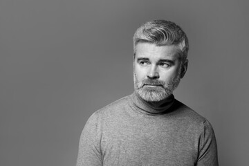 Fototapeta premium Portrait of handsome man on grey background, space for text. Black and white effect