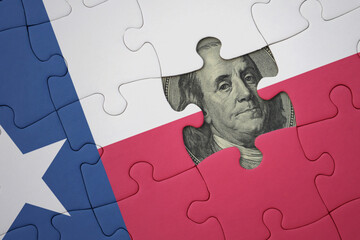 puzzle with the national flag of texas state and usa dollar banknote. finance concept